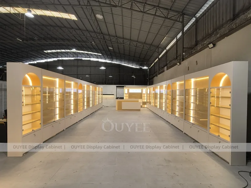 Long Beige Perfume Showroom With Backlit Arch Shelving
