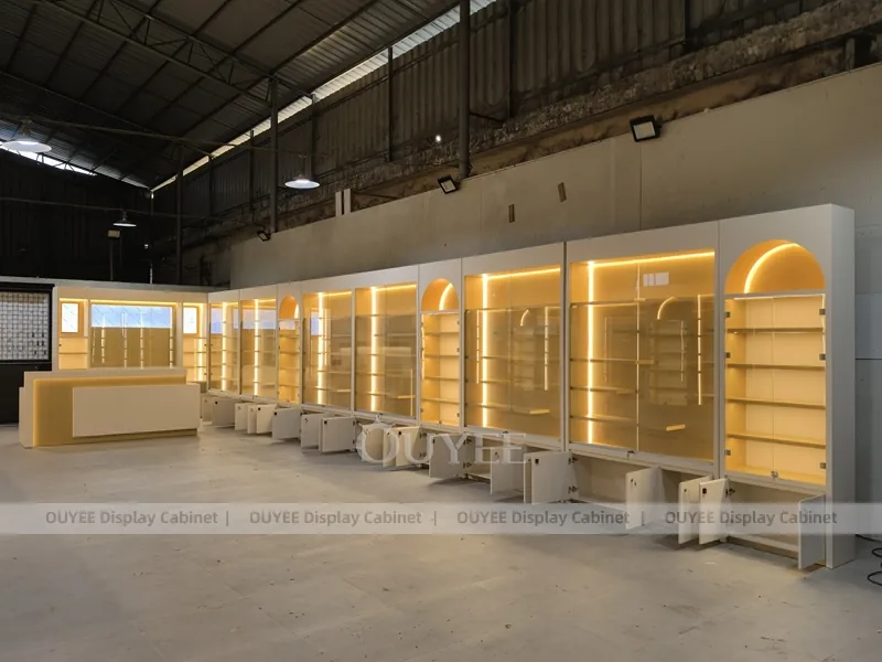Long Beige Perfume Showroom With Backlit Arch Shelving