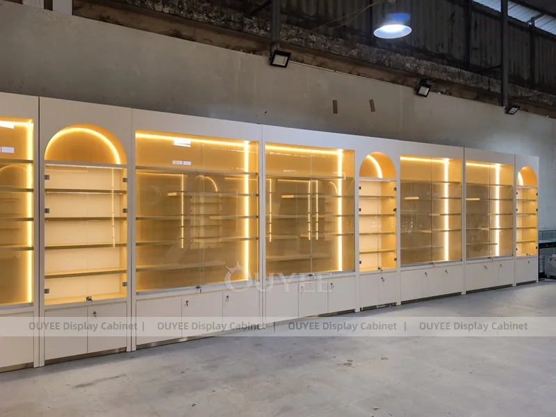 Long Beige Perfume Showroom With Backlit Arch Shelving