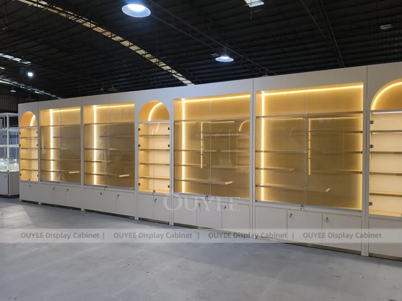 Long Beige Perfume Showroom With Backlit Arch Shelving