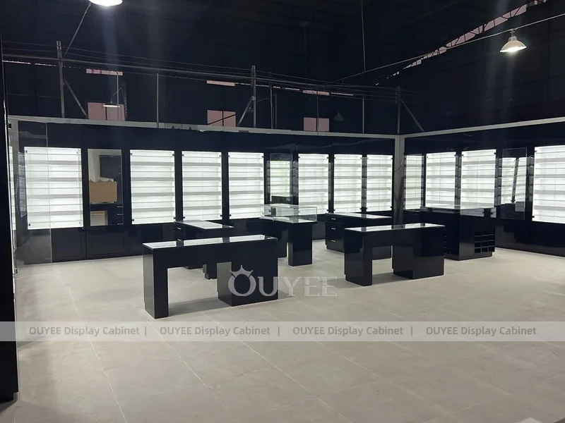 Black Optical Shop Interior with Illuminated Wall Shelves and Display Tables_01