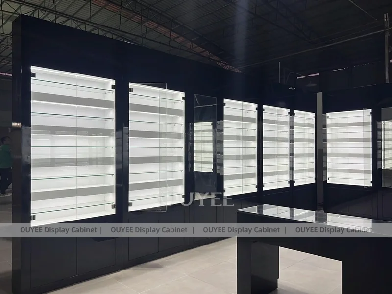Black Optical Shop Interior with Illuminated Wall Shelves and Display Tables_04