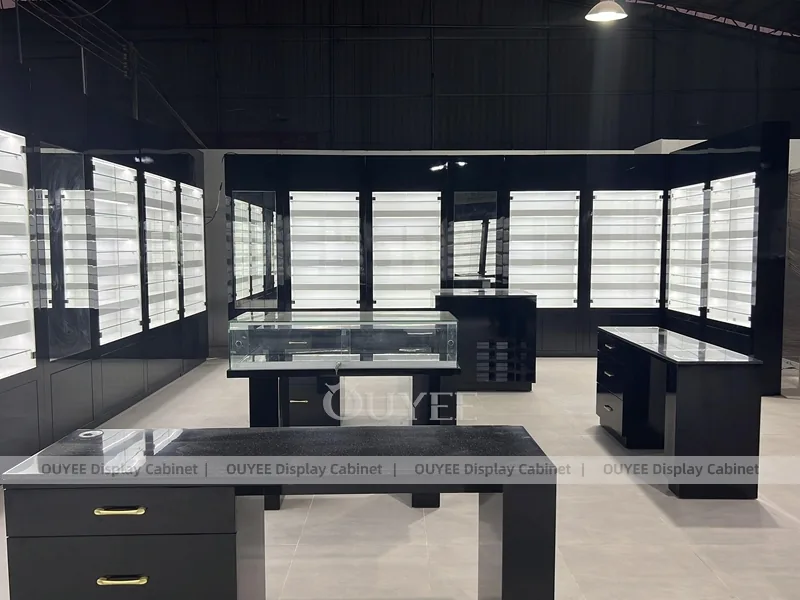 Black Optical Shop Interior with Illuminated Wall Shelves and Display Tables_05