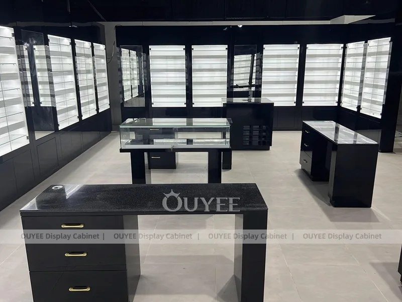 Black Optical Shop Interior with Illuminated Wall Shelves and Display Tables_06