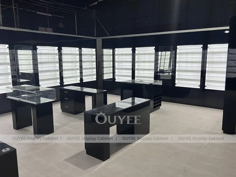 Black Optical Shop Interior with Illuminated Wall Shelves and Display Tables_09