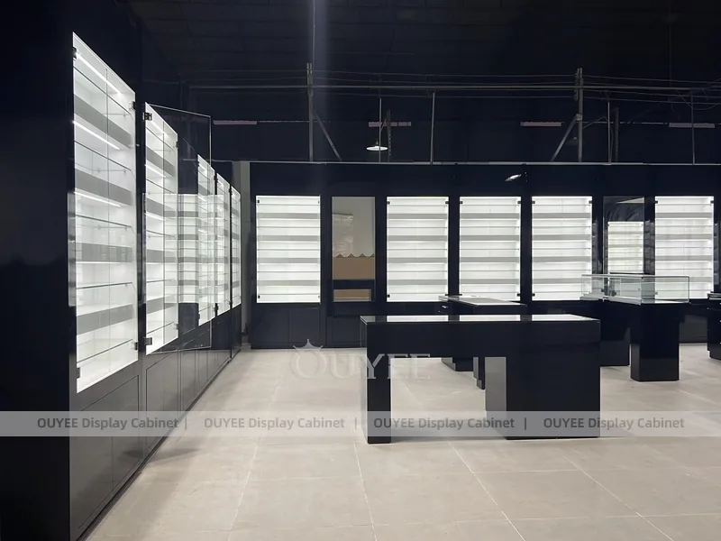 Black Optical Shop Interior with Illuminated Wall Shelves and Display Tables_10