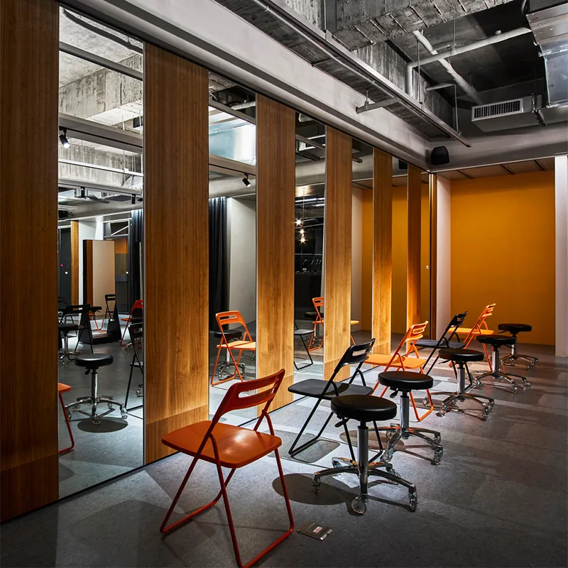 Industrial Salon Styling Table with Orange Chairs and Wood Partitions_04