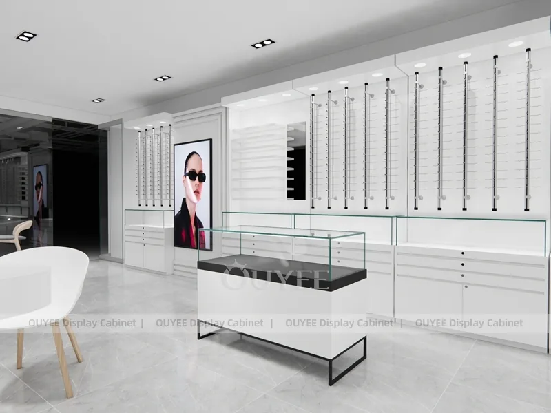Design minimal bianco per negozio di ottica con scrivania per consulenze e armadi a parete_03