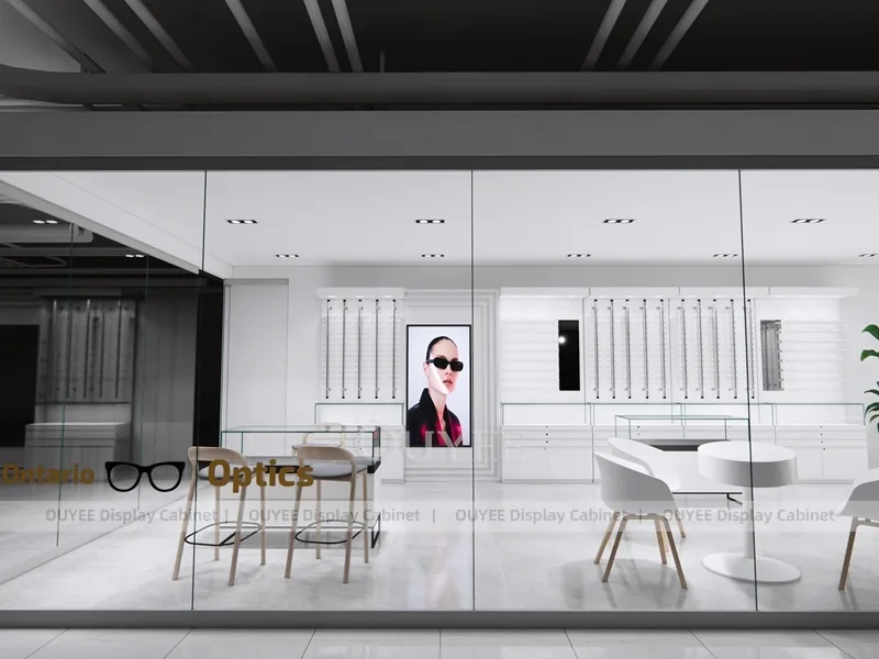Design minimal bianco per negozio di ottica con scrivania per consulenze e armadi a parete_07
