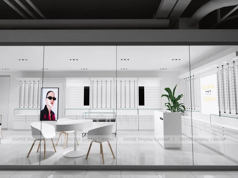 Design minimal bianco per negozio di ottica con scrivania per consulenze e armadi a parete_08