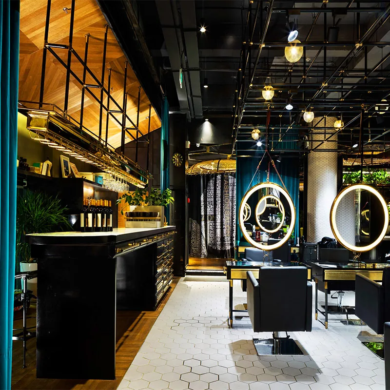 Modern Salon Interior with Circular Lighted Mirrors and Black Chairs_02