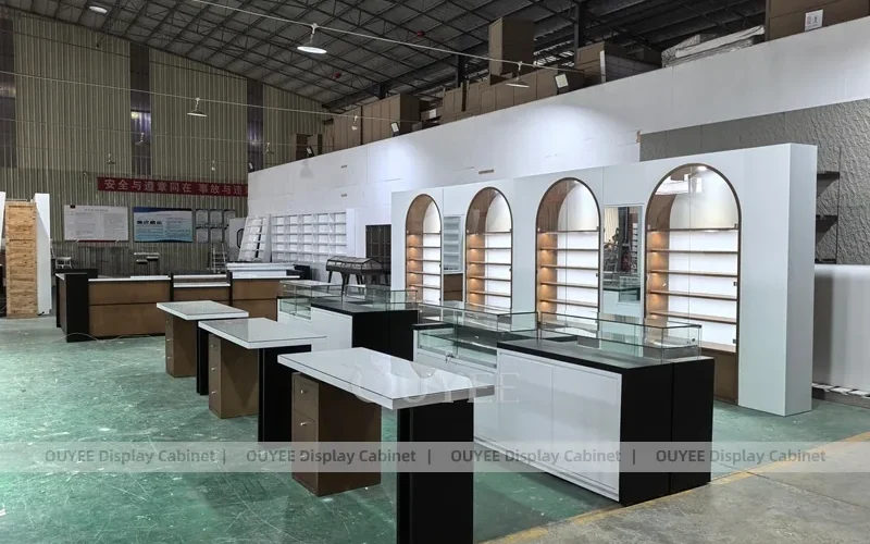 Arched Optical Store Display Wall with Black Island Tables_01