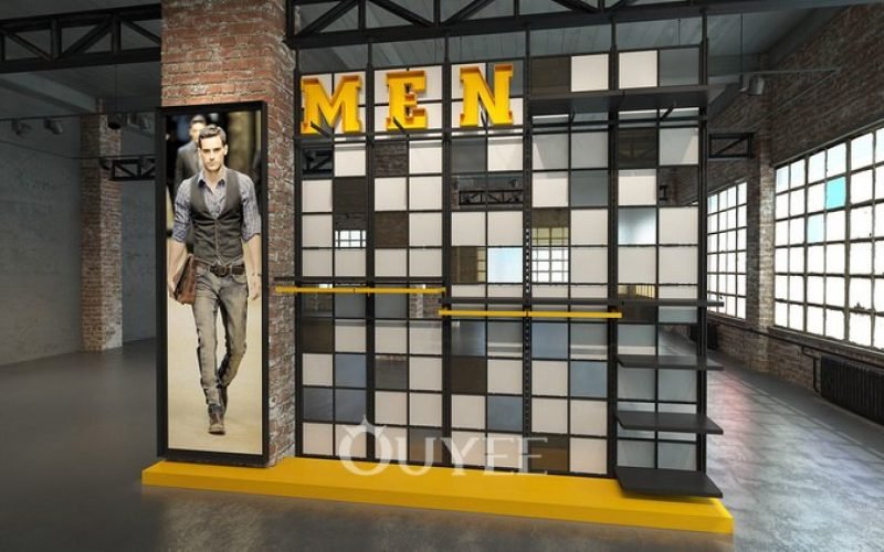 Black and yellow menswear wall display with garment rails and shelves