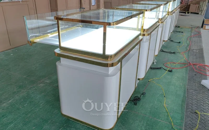 White jewelry glass showcase counters with gold trim photographed in the workshop